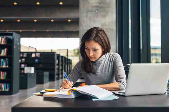 Female student studying at university library